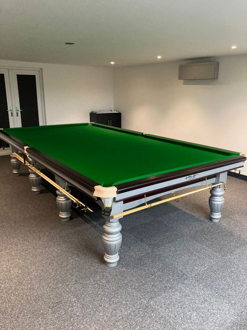 Bespoke garden games room with pool table, bar and big-screen TV