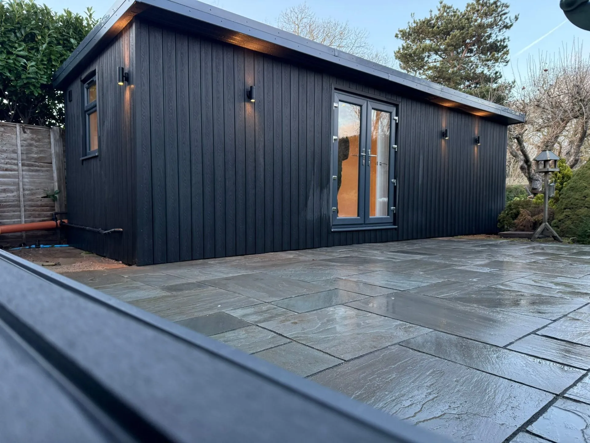 Charcoal composite annexe on stone patio