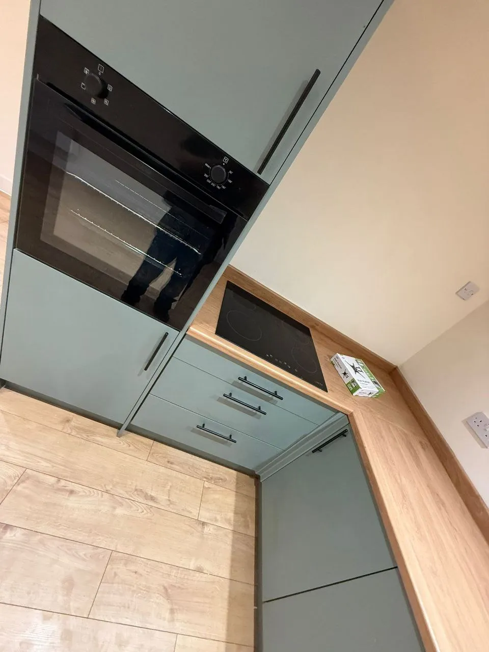 Fitted kitchen with built-in oven and hob